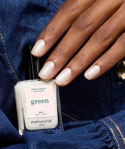 Hand holding Moon nail polish GREEN™ Manucurist - luminous pearly white, vegan and non-toxic L'Officina Paris