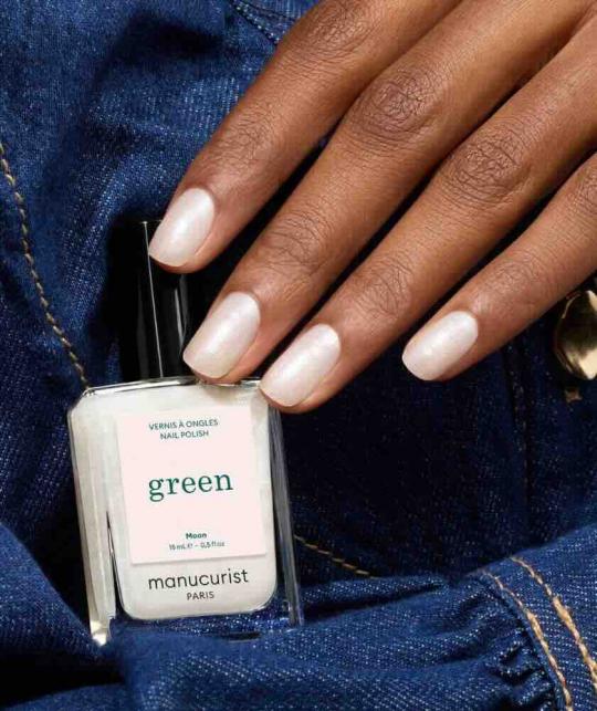 Hand holding Moon nail polish GREEN™ Manucurist - luminous pearly white, vegan and non-toxic L'Officina Paris