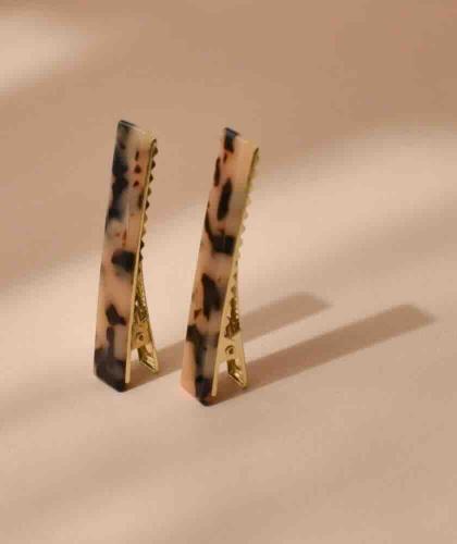 BACHCA Paris Flat Tortoiseshell Barrettes in cellulose acetate on a warm beige background