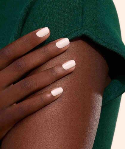 Crème manicure with GREEN™ Manucurist nail polish on medium-dark skin