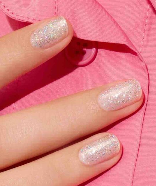 Mermaid Manucurist Green nail polish, sheer holographic glitter polish on close-up nails