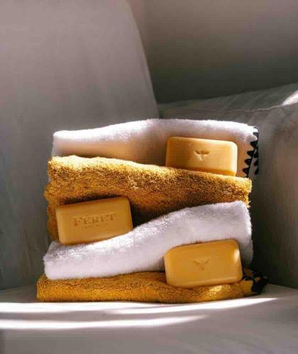 Féret Parfumeur Honey Scented Soaps in a soft and bright setting with a bath towel